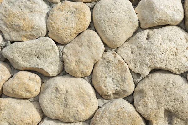 Yelow oval stones in the wall like background