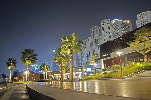 DUBAI, UAE - 17 JUNE 2015 : Promenade in Dubai Marina at night, UAE. Dubai Marina is a district in Dubai with artificial canal city who accommodates more than 120,000 people at Persian Gulf.