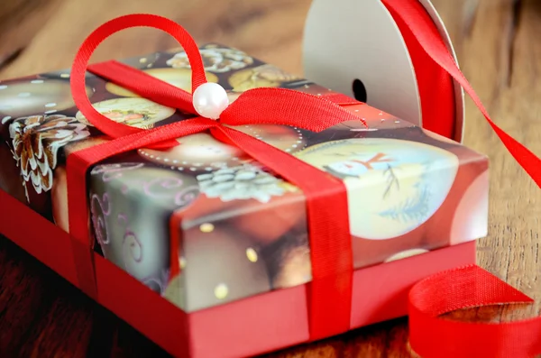 Red present box decorated with red ribbon