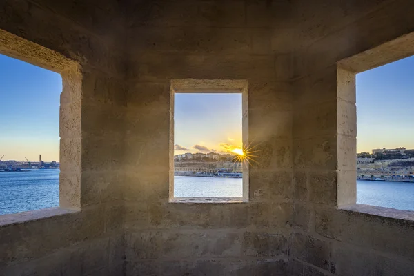 Malta, Senglea - Magic hour view of Valletta inside of watch tower at Gardjola Gardens, Fort San Michael