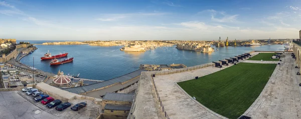 Valletta, Malta - Panoramic skyline view of the Grand Harbor of Valletta from Upper Barrakka Gardens at daylight with blue sky