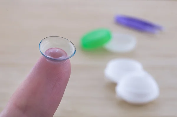 The contact lens on the finger. Blurred vision