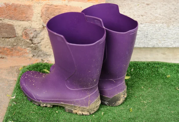 Modern muddy rubber boots