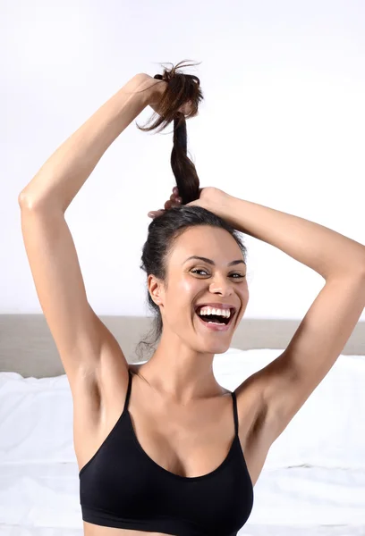 Beautiful woman pulling hair and smile at home