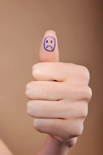 Woman hand with thumb up and sad smile draw