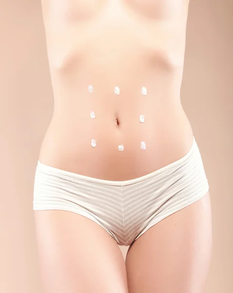 Woman body care with smiley around belly