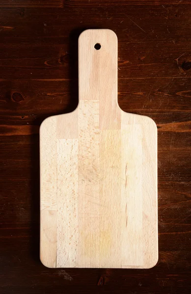 Chopping board on dark wooden table