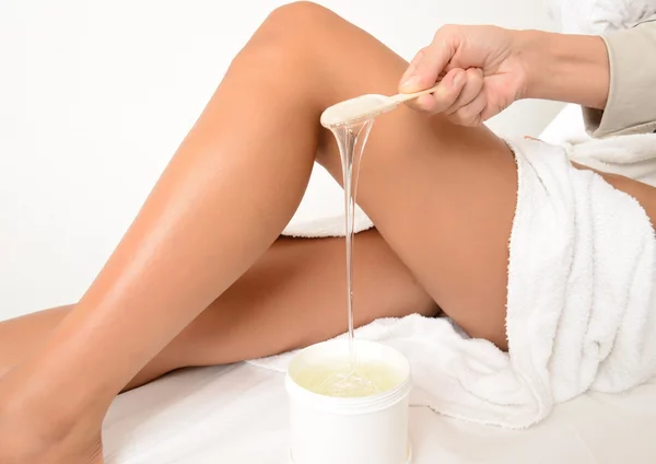 Woman preparing for a wax legs treatment