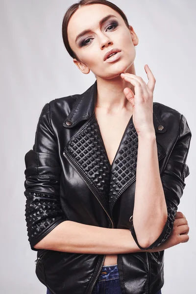 Fashion style girl portrait. Beautiful fashion woman with professional styling, hairdress and makeup.