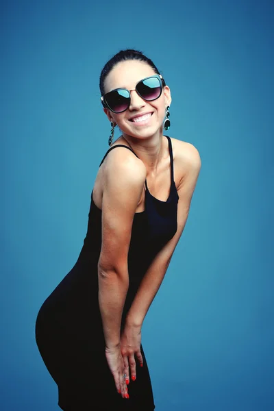 Surprised young woman in glasses over gray background