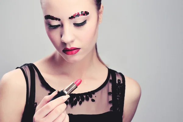 Sexy Beauty Girl with Red Lips and Nails. Provocative Make up. Fashion Brunette Portrait isolated on a white background.