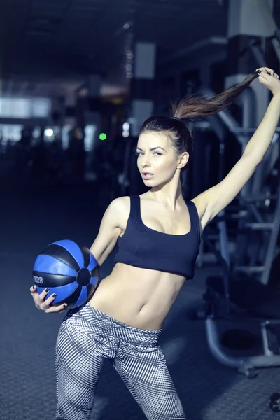 Work out fitness woman doing sit ups abs abdominal crunches core exercises with medecine ball