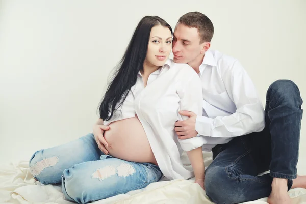 Indoor portrait of beautiful asian pregnant woman and her husband