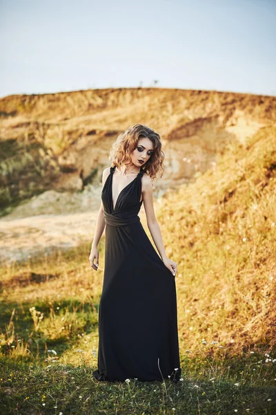 Very beautiful slim girl with long hair in a long dress