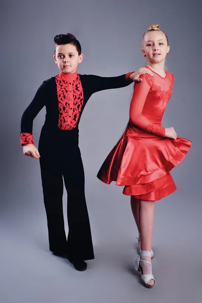 Two beautiful children dancing ballroom dance sport