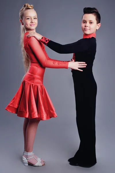 Two beautiful children dancing ballroom dance sport