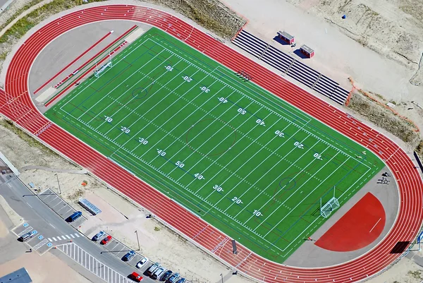 Aerial photo of an American high school football/soccer field with a track and field track surrounding it