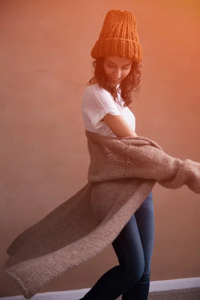 Happy woman in knitted sweater and hat