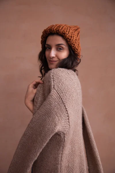 Happy woman in knitted sweater and hat