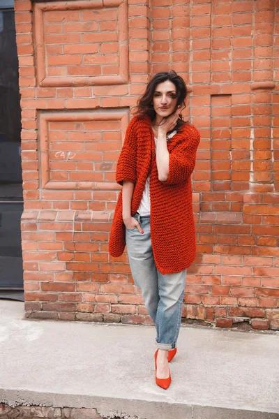 Woman wearing knitted colorful coat outdoor