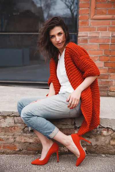 Woman wearing knitted colorful coat outdoor