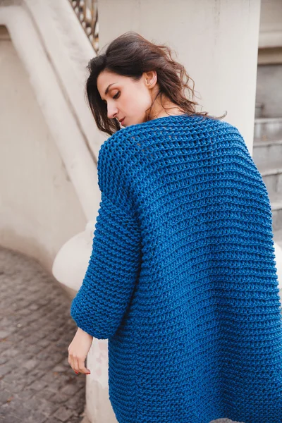 Woman wearing knitted colorful coat outdoor