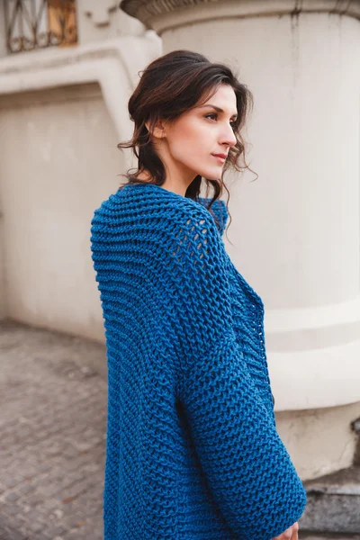 Woman wearing knitted colorful coat outdoor