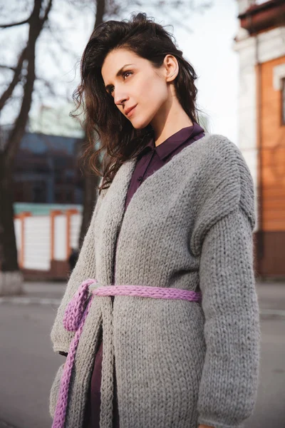 Woman wearing knitted colorful coat outdoor