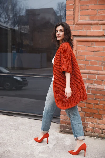 Woman wearing knitted colorful coat outdoor