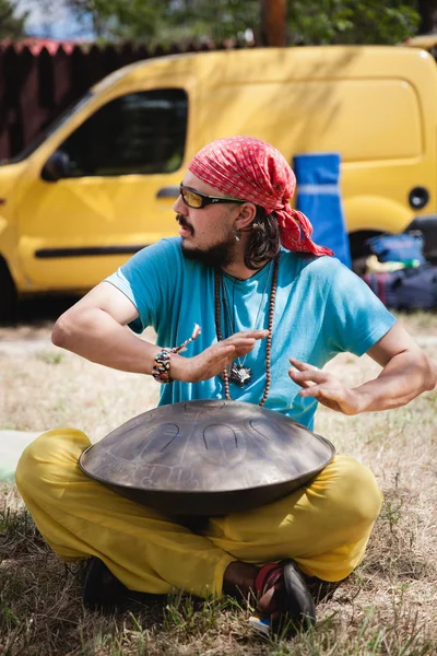 Man plays ethnic music on hang at Avatar Yoga Festival