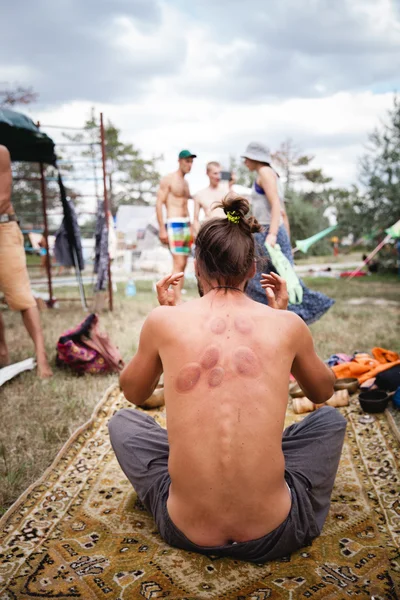 Medical pot prints on mans back at Avatar Yoga Festival