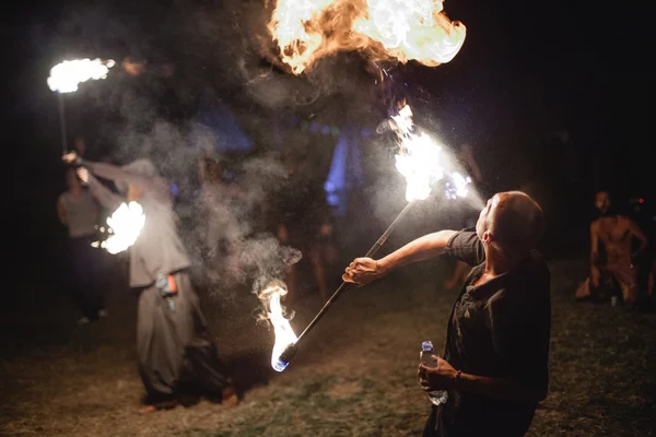 Men making fire show at Avatar Yoga Festival