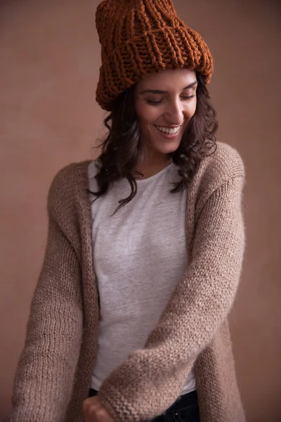 Happy woman in knitted sweater and hat