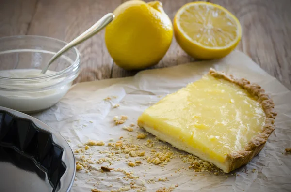 Lemon tart with lemons and cream
