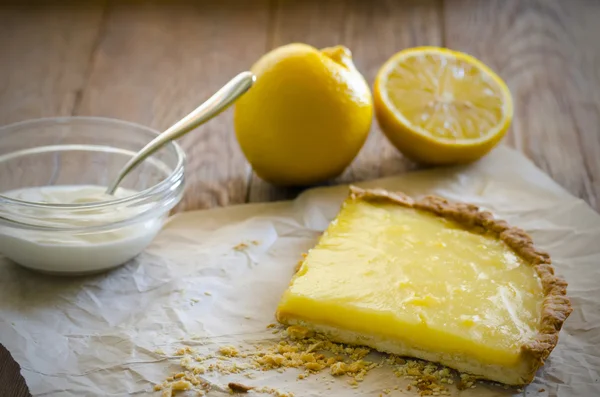 Lemon tart with lemons and cream