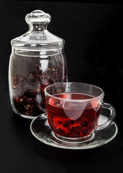 Red hibiscus tea on black background