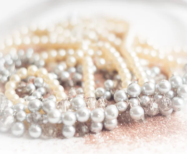 Pearl necklace with blurred background on white