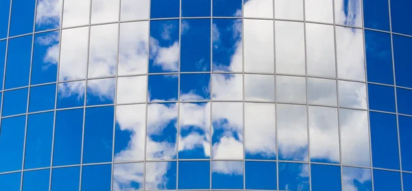 Office building with sky reflection in windows
