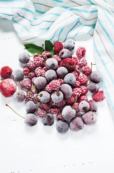 Summer fresh berries, healthy food, white wooden background.