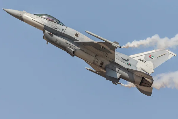 Gray jet fighter General Dynamics F-16 Fighting Falcon display demo flight during Dubai AirShow. Location: (DWC) Dubai World Central - Al Maktoum International, Dubai, United Arab Emirates; Date:21.11.2013