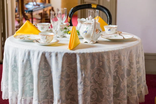 Dining table in vintage style with elegant table setting.