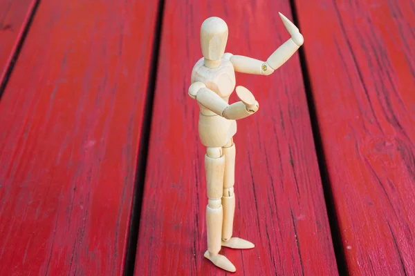 Wooden figure raising arm / hand and introduce