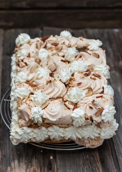 Meringue cake, whipped cream and almonds