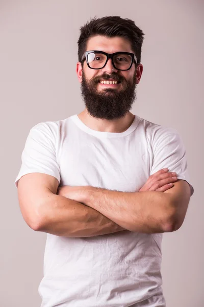 Bearded man in glasses with crossed hands