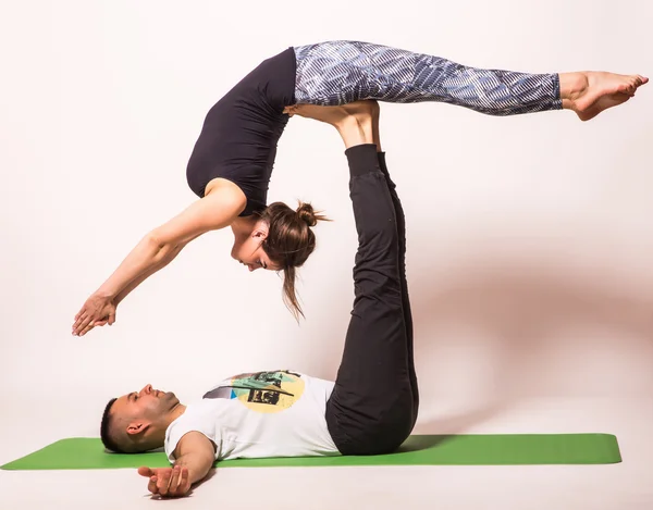 Young healthy couple in yoga position