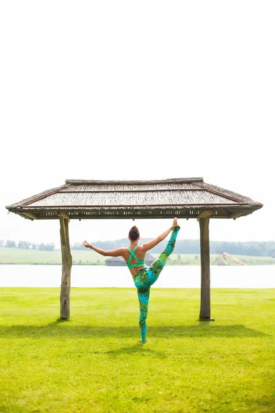 Yoga girl training outdoors on nature background. Yoga concept.