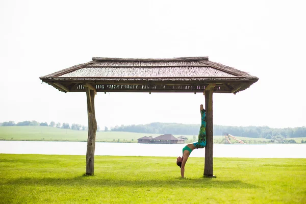 Yoga girl training outdoors on nature background. Yoga concept.