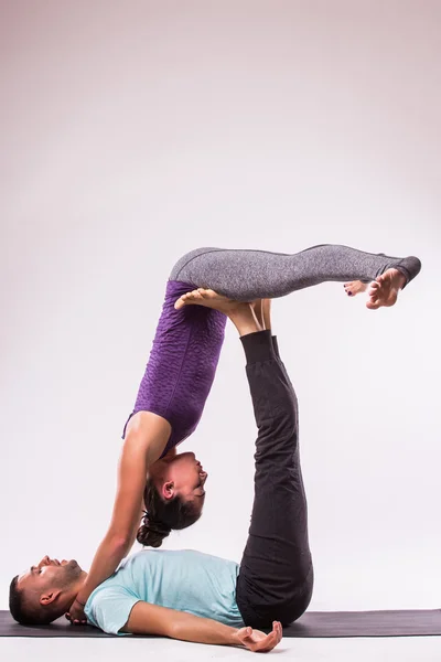 Young healthy couple in yoga