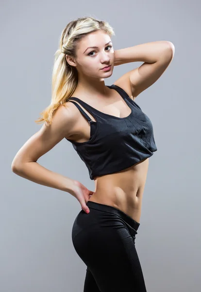 Attractive fit woman exercising in studio