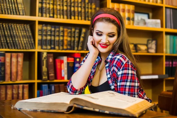 Clever female student hair ponytail girl  sitting  in  library with  books. Indoor